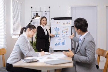 Asian business teamwork working on digital tablet with analysis report and advisor showing plan, Financial analysis and Marketing teamwork concept.