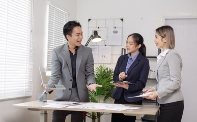 Asian business teamwork working on digital tablet with analysis report and advisor showing plan, Financial analysis and Marketing teamwork concept.