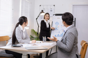 Asian business teamwork working on digital tablet with analysis report and advisor showing plan, Financial analysis and Marketing teamwork concept.