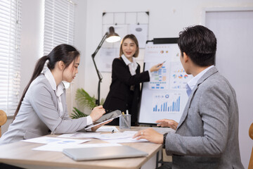 Asian business teamwork working on digital tablet with analysis report and advisor showing plan, Financial analysis and Marketing teamwork concept.