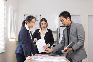 Asian business teamwork working on digital tablet with analysis report and advisor showing plan, Financial analysis and Marketing teamwork concept.