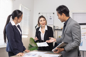 Asian business teamwork working on digital tablet with analysis report and advisor showing plan, Financial analysis and Marketing teamwork concept.