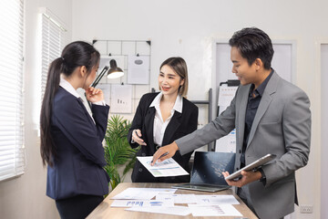 Asian business teamwork working on digital tablet with analysis report and advisor showing plan, Financial analysis and Marketing teamwork concept.