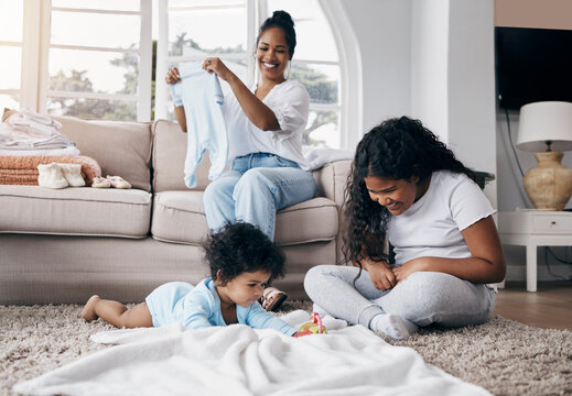 Playing, children or mom in home for laundry for organizing clothes or washing in happy family. Games, smile and mother folding fabric garment or towel for housekeeping or wellness for kids siblings