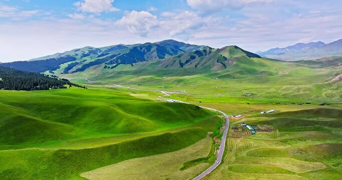 Green grassland with mountain natural landscape in summer. Yizhao Highway is one of the most beautiful highways in Xinjiang, China.