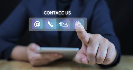 Customer support hotline Contact us people connection. Businessman using computer keyboard with the email, call phone, address, Chat message icons.