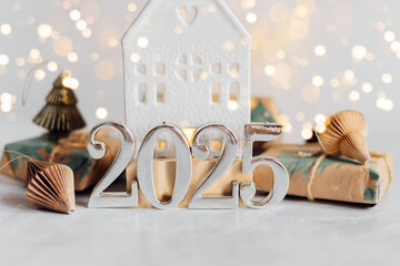 Christmas and New Year card. Number 2025 on holiday background with lights bokeh garlands. Holiday postcard. Happy New Year 2025 Card Concept