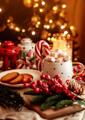 Festive Christmas scene with marshmallows in a cup, candy cane, cookies and cozy holiday decorations. Perfect for Christmas food, holiday vibe, winter warmth, and festive season. 