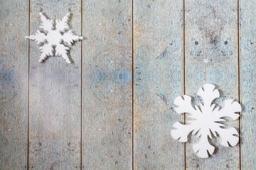 White decorative snowflakes on wooden background, copy space