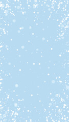 Magic falling snow christmas background. Subtle flying snow flakes and stars on light blue winter backdrop. Magic falling snow holiday scenery.   Vertical vector illustration.