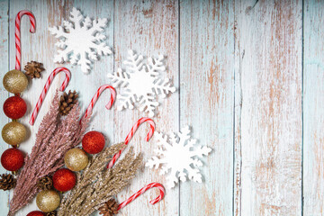 Christmas decorations on a wooden background: Christmas tree balls, branches, snowflakes and candy...