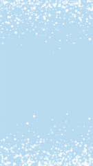 Fototapeta premium Falling snowflakes christmas background. Subtle flying snow flakes and stars on light blue winter backdrop. Beautifully falling snowflakes overlay. Vertical vector illustration.