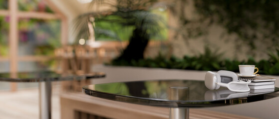 A space for displaying products on a table in a contemporary coffee shop with indoors garden.