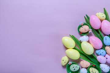 Flowers on purple background. Easter top view postcard with copy space
