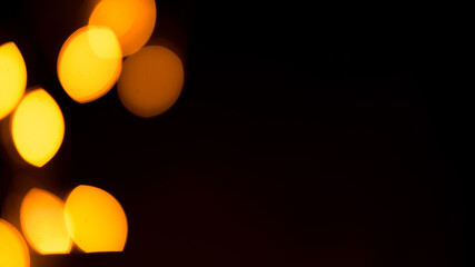 Bright yellow, gold lights, bokeh on black background