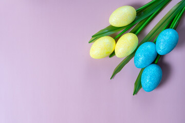 Flowers on purple background. Easter top view postcard with copy space
