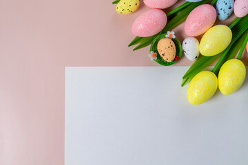 Easter beige background with flowers and eggs. A4 paper sheet copy space postcard top view