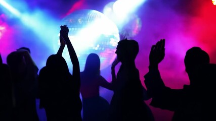 Dazzling silhouettes dancing joyfully beneath a shimmering disco ball