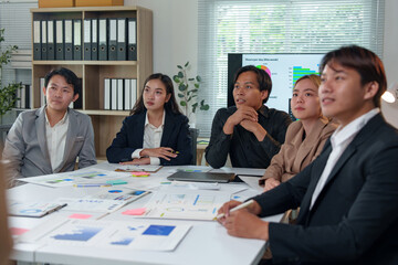 Asia business group meeting and discuss new startup concept projects Business team planning, strategic analysis and brainstorming with office paper reports.