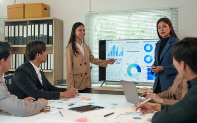 Asia business group meeting and discuss new startup concept projects Business team planning, strategic analysis and brainstorming with office paper reports.