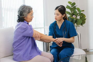 woman in a purple shirt is being helped by a woman in a blue uniform