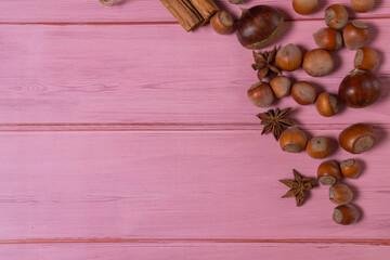Pumpkin, chestnuts, anise, cinnamon, hazelnuts on a wooden background. Top view, copy space
