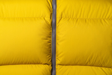 Yellow down jacket with zipper close-up