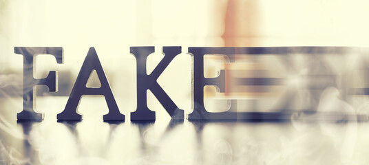 The concept of modern information technology. Fake and facts in the news. The letters spelled the...