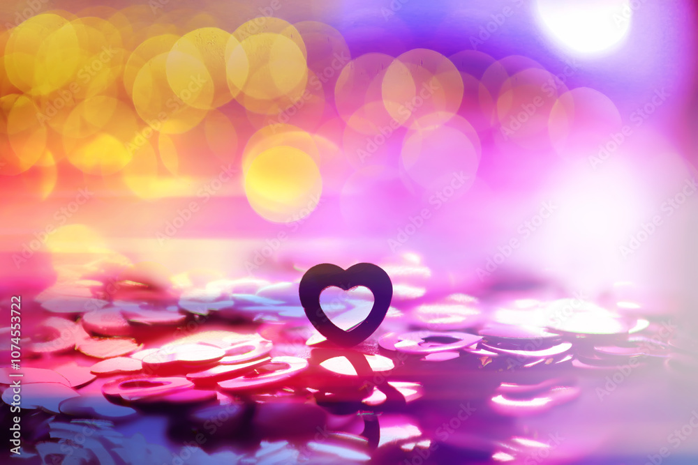 Wall mural abstract colored background. red toy in the shape of a heart on a glitter and bokeh background.