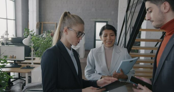 Slow motion of Middle Eastern businesswoman walking in office then meeting colleagues talking discussing business. Job and teamwork concept.