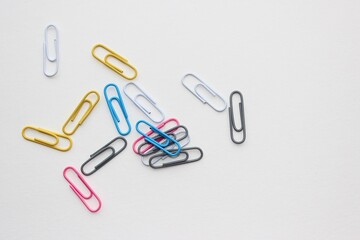 Office paper clips for important documents and files. White background, isolation.