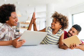 Obsessed to tech devices happy african american family using digital tablet, computer, smartphones.