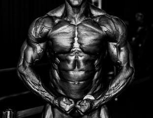 Fototapeta premium bodybuilder body part details. bodybuilder in competition, detail.