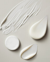 Group of cosmetic white cream flat lay swatches against a  beige background 
