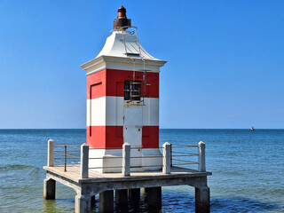 Close up of red and white lighthouse in Lignano Sabbiadoro.