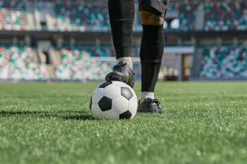 Obraz premium african american man holding a soccer ball in the stadium