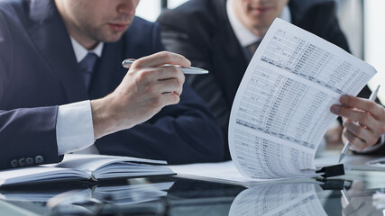 Closeup businessman sign contract or legal document with pen in his hand during corporate meeting for business deal