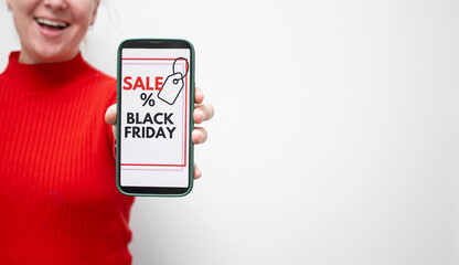 Close up of a happy smiling female holding a smartphone with screen displaying a Black Friday online sale