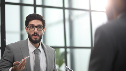 Fototapeta premium the manager receives a partner in his office sitting at the table