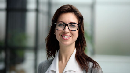 smiling enthusiastic and accomplished young woman posing for camera