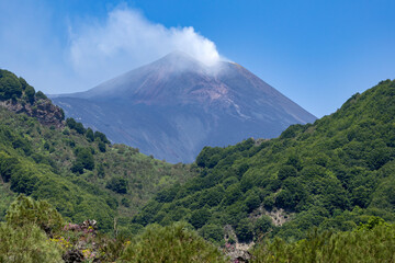 The smoking Volcano Etna on the heights of Catania, Sicily, Italy