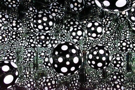 Porto, Portugal - Mai 28, 2024 - An art installation showing a mirror room with black balls and white dots, part of the art series Polka Dots by Yayoi Kusama, at the Serralves Foundation