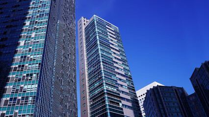 Naklejka premium Cityscape with Skyscrapers Against a Blue Sky