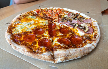 Four Seasons Pizza, Quattro Stagioni with 4 Types of Toppings with Salami, Tomato, Mushrooms,Meat