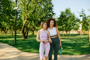 Fototapeta premium A joyful couple strolls through a lush green park under the sun.