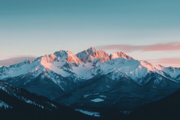 Fototapeta premium Snow Capped Mountain Range at Dramatic Sunset Overlooking Picturesque Alpine Wilderness