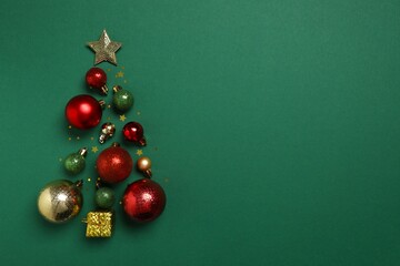 Festive balls in the form of a Christmas tree on a color background, top view