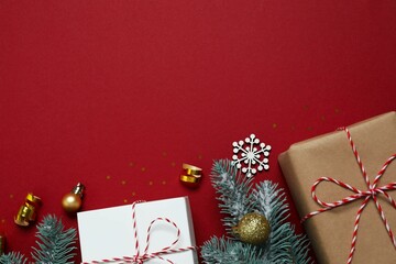 Beautiful gift boxes tied with bows and Christmas decorations on color background 