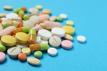 Various medicine pills on color background 