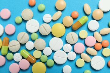 Various medicine pills on color background 